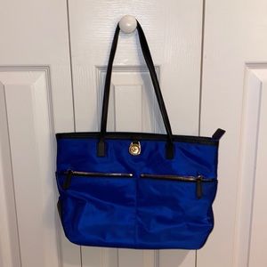 Blue MICHAEL KORS bag with black straps and gold zippers